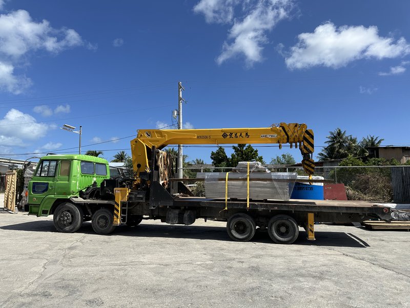 Boom truck with yellow hydraulic crane