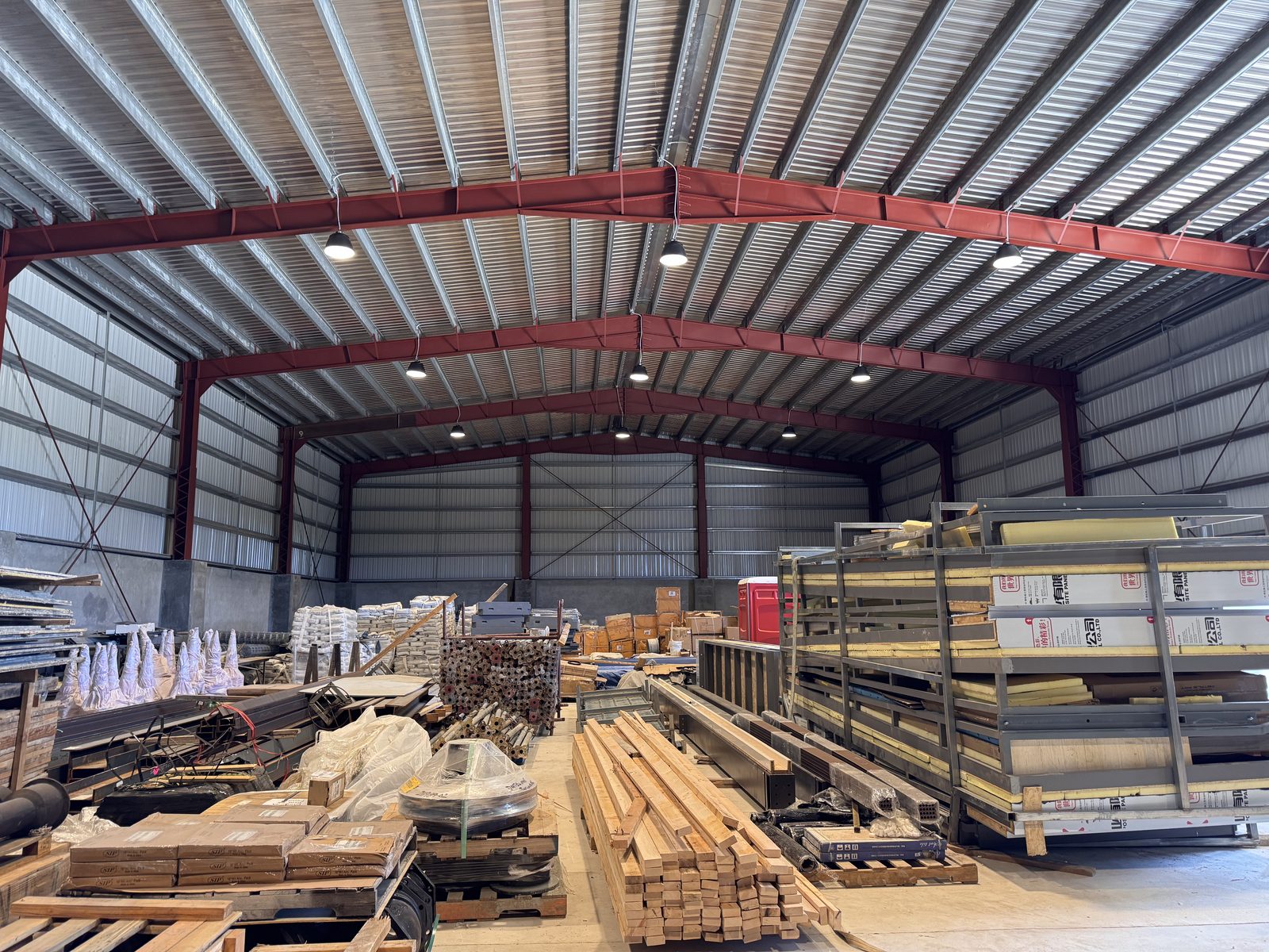 Hong Ye warehouse exterior with boom lifts and staging area